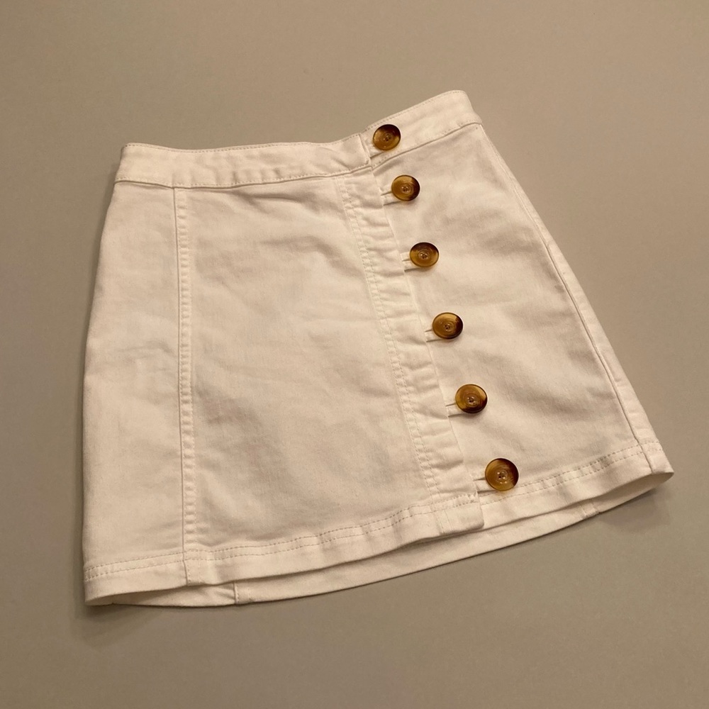 a white jean skirt with buttons